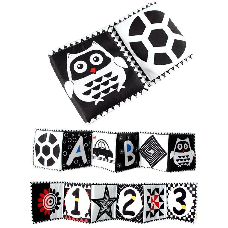 Black and white contrast cloth book cover shown for newborn visual stimulation and crib play.