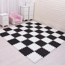 Black and white EVA foam puzzle mat 18-piece set for a modern nursery play area.