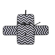 Black and white zigzag baby changing pad with a wipe clean surface for mess-free nappy changes anywhere.