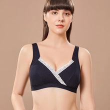 Black wireless cotton nursing bra with lace trim on a beige background for nursing comfort.