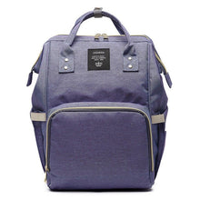 Blue diaper backpack multi-pocket organizer view for sorting baby items during outings.
