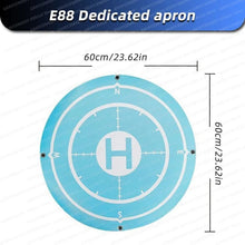 Blue drone landing pad with H marker as an E88 Pro flight accessory for clean takeoffs in parks and fields.