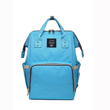 Blue maternity diaper bag detail of the carry handle for easy stroller attachment and travel.