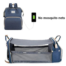 Portable baby bed diaper mommy bag in blue fitted with a mosquito net for outdoor naps.