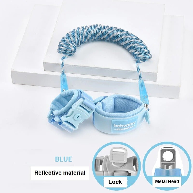 Blue toddler walking wrist link safety band with reflective trim for busy outdoor environments and shopping trips.