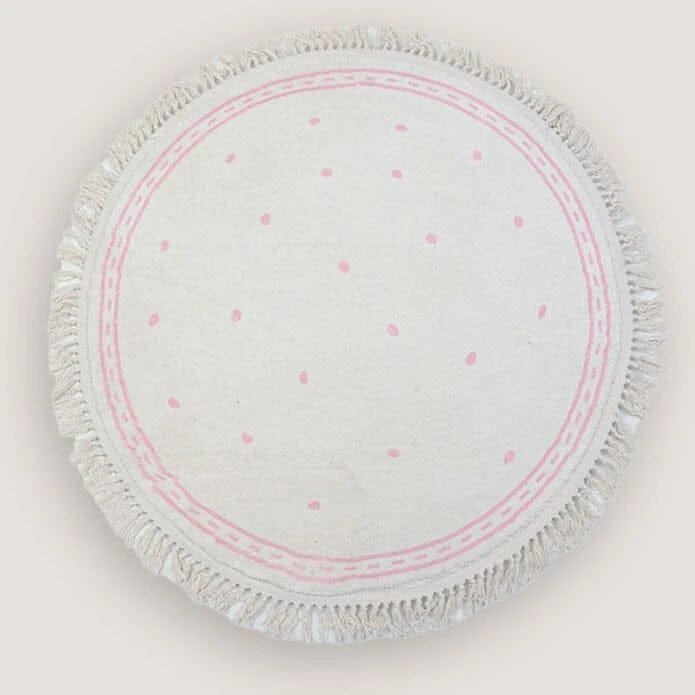 Round white cloth with pink polka dots and frayed edge