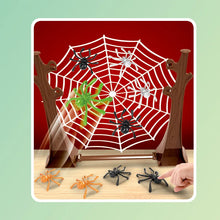 White spider web on a red backdrop with spiders on the web and four spiders on the table in front