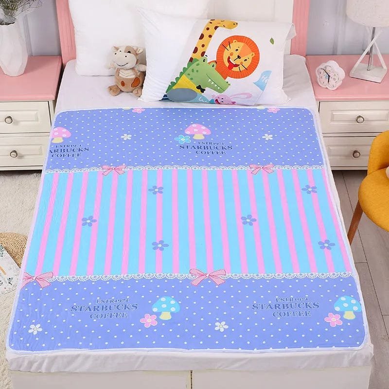 Children's bed with a colorful Starbucks-themed blanket and pillows.