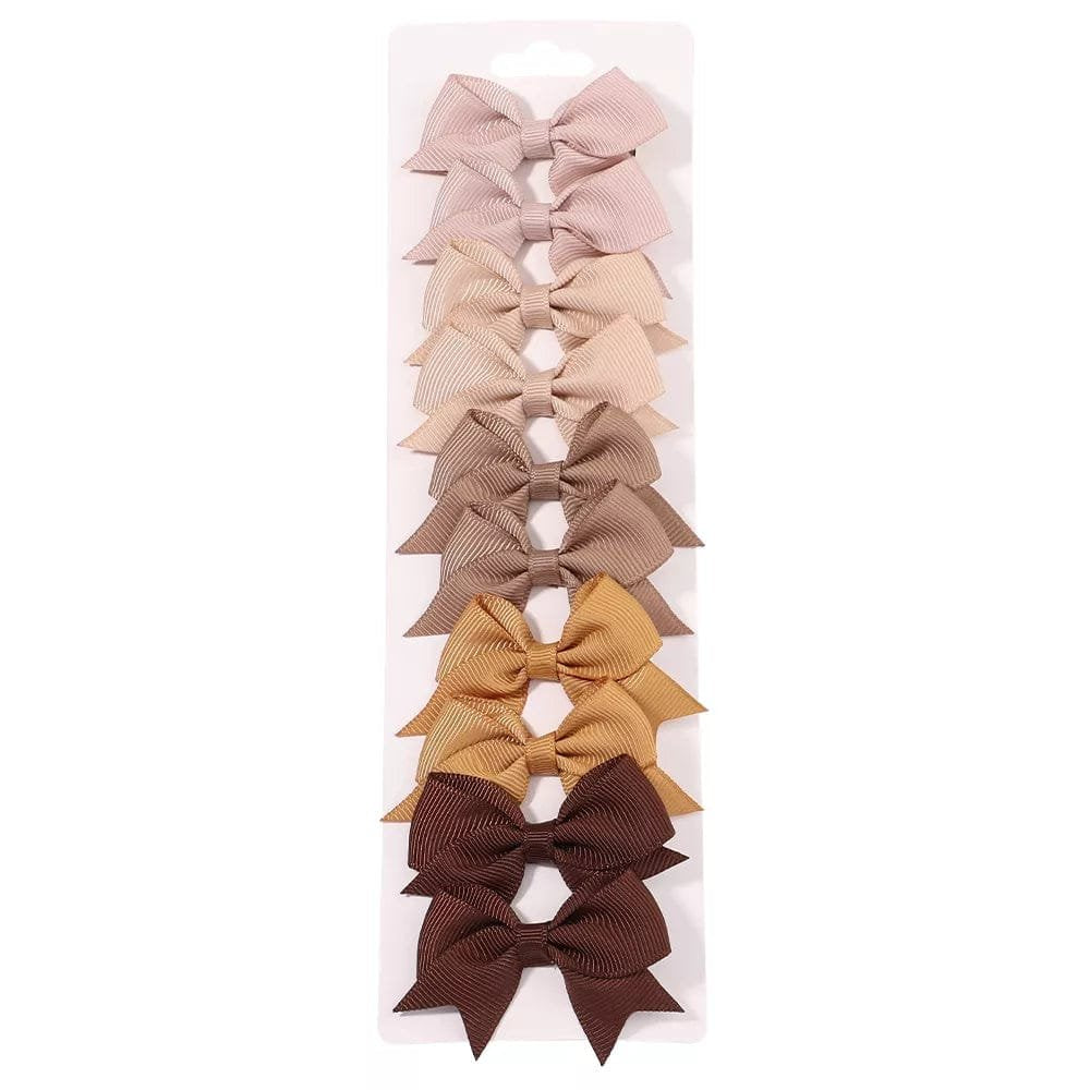 Brown bow hairpins in a presentation box for neutral everyday hairstyles and gifting.