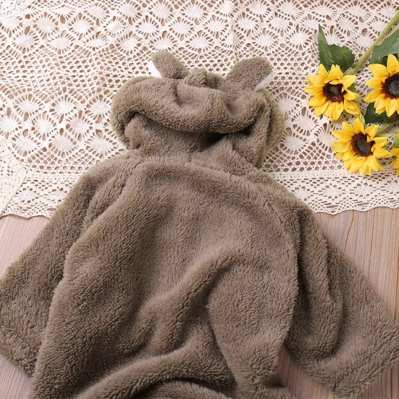 Brown cartoon baby romper styled flat lay for autumn dressing, gifting, and nursery photos.