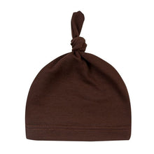 Brown cotton knot baby beanie sleep cap from an alternate angle for neutral newborn outfit styling.