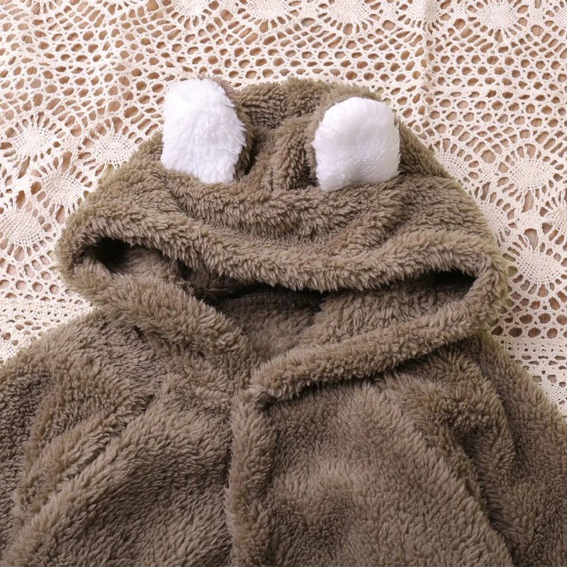Soft brown plush long-sleeve baby romper for cosy indoor wear and cool-weather naps.