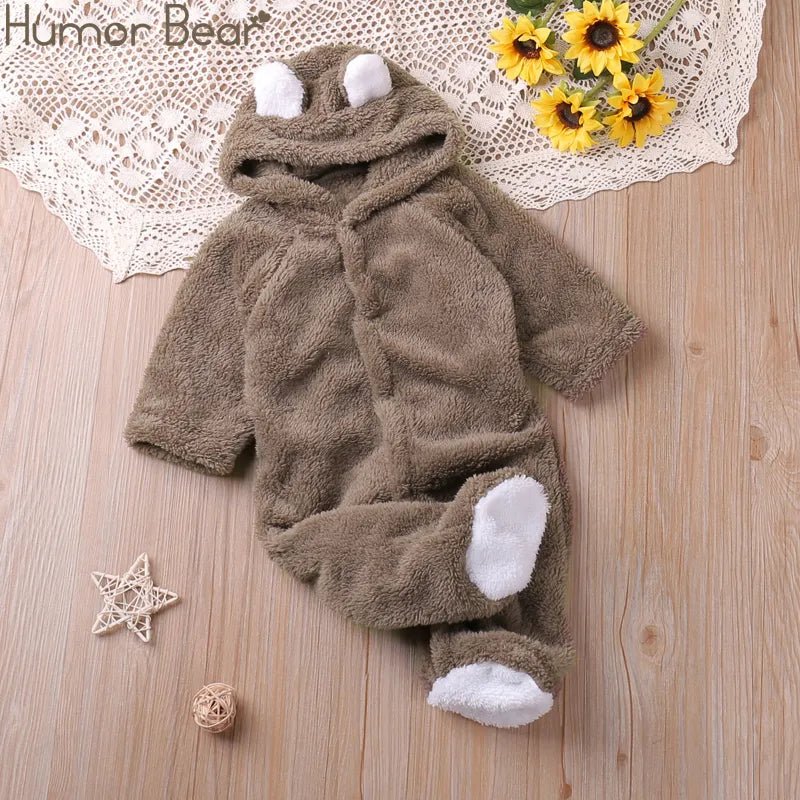 Brown cartoon baby romper with white accents laid flat for easy dressing and autumn outings.