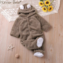 Brown cartoon baby romper with white accents laid flat for easy dressing and autumn outings.