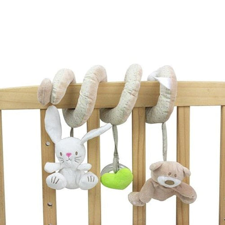 Plush toys hanging from a crib bar with a white background