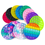 Assorted colorful pop-it fidget toys on a white background