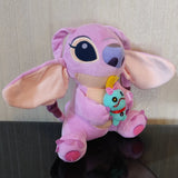 Pink plush toy with a small blue character attached, on a neutral background