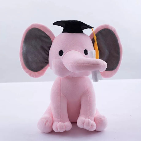 Pink plush elephant toy wearing a black graduation cap on a white background