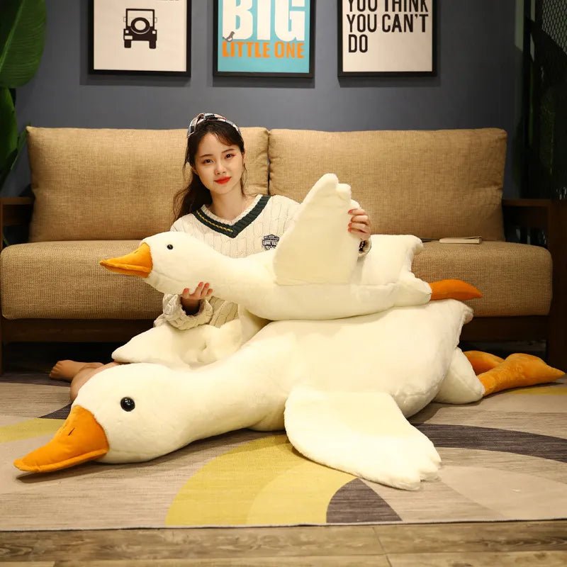 Person holding a large plush duck toy in a living room setting
