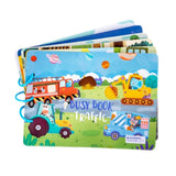 Colorful children's busy book with traffic-themed illustrations on a white background