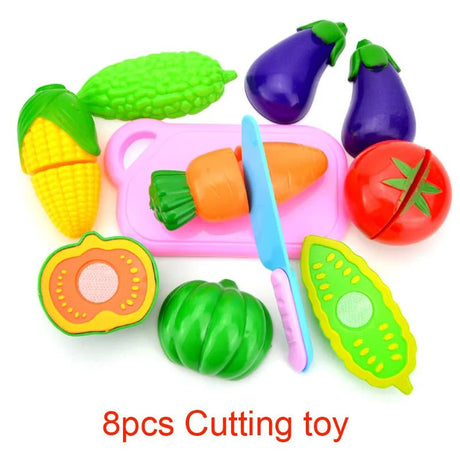 Colorful toy cutting vegetables set with a knife on a white background