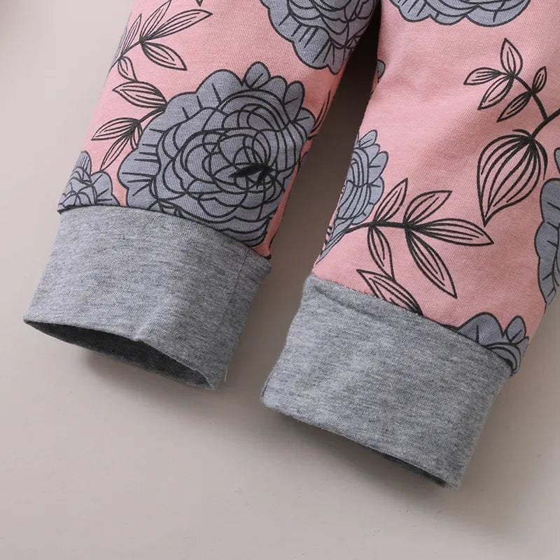 Floral-patterned leggings with gray cuffs on a beige background