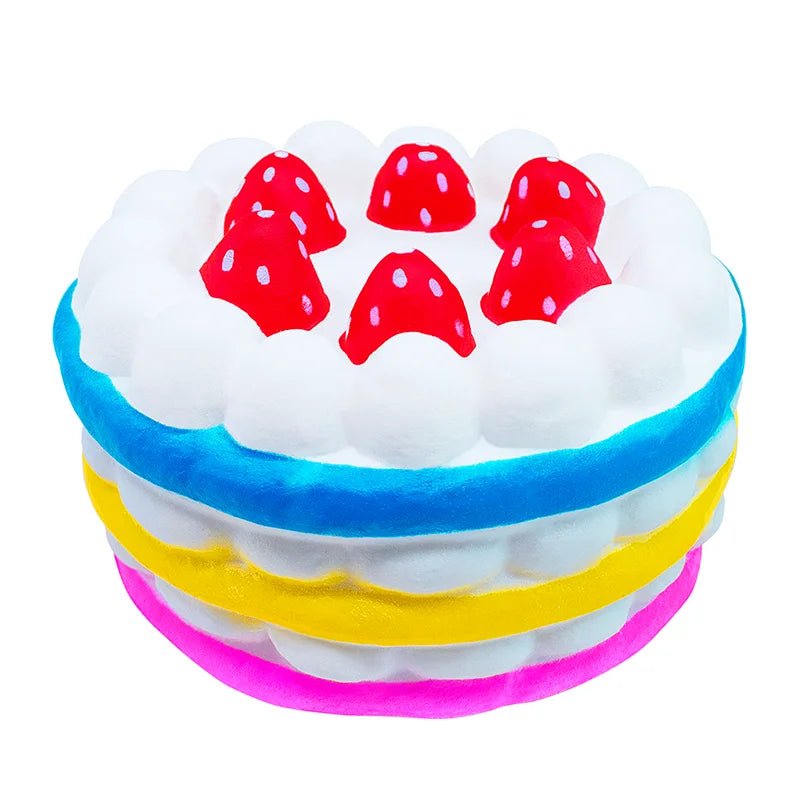 Toy resembling a cake with colorful layers and red polka dot decorations on a white background