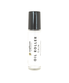 Calm essential oil roller in a clear bottle with black cap for on-the-go relaxation.