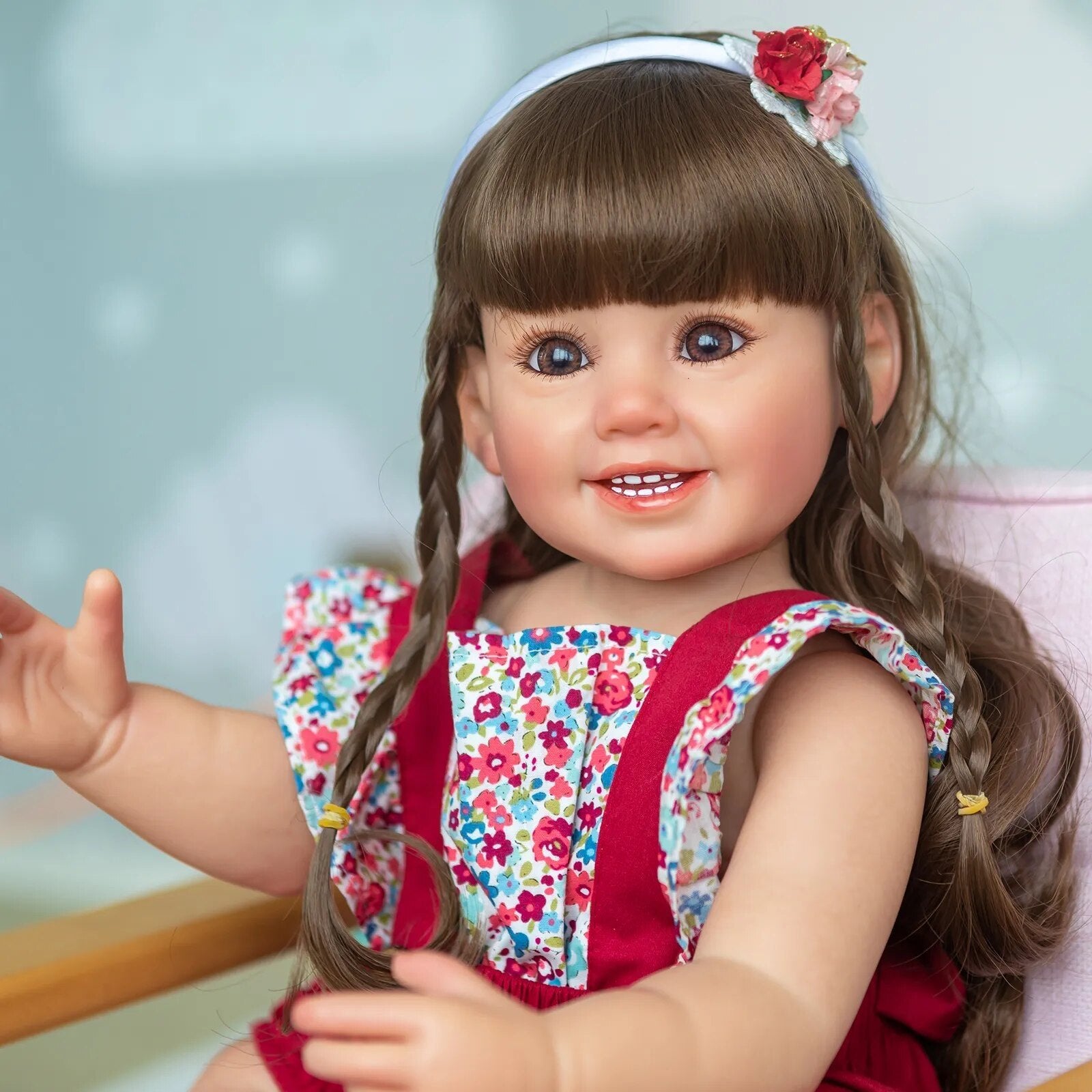 Cammi Smile soft silicone Reborn Baby Doll with hand-painted features and braided hair for lifelike cuddling and display.