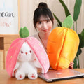 Carrot Rabbit in Strawberry Bag soft plush toy held in hand for cuddling, imaginative play, and kids gifting.