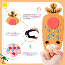 Carrot-shaped remote control baby teether held in hand for easy gripping, gum soothing, and teething relief.