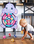 Child playing with a dartboard shaped like an elephant.