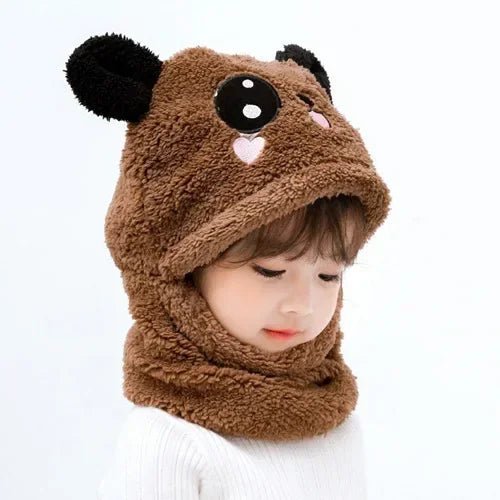 Child wearing a brown bear-themed hood.