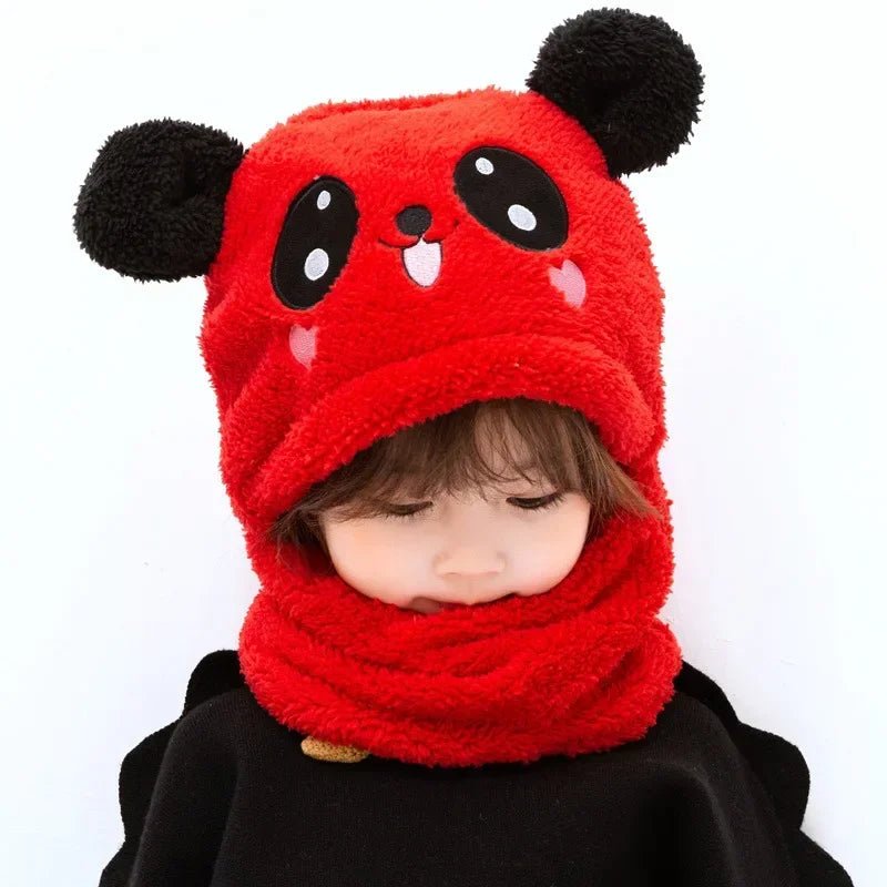 Child wearing a red panda-themed hat and scarf