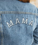 Blue denim jacket with 'MAMA' embroidered.