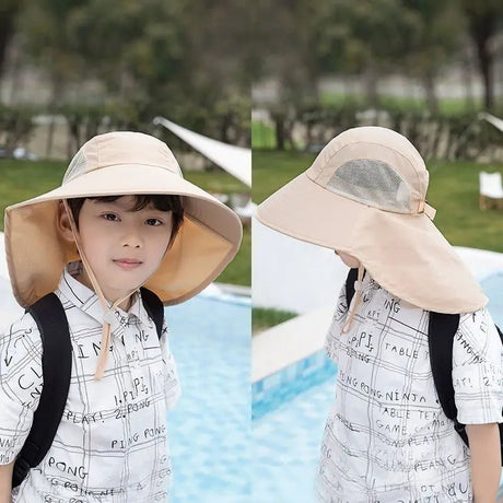 Child wearing a large beige sun hat by a poolside with trees in the background