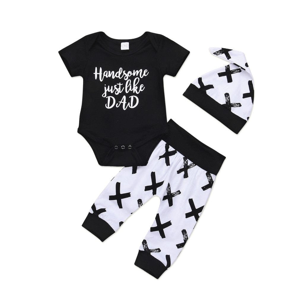 Black and white baby outfit with 'Handsome just like DAD' text on a plain background