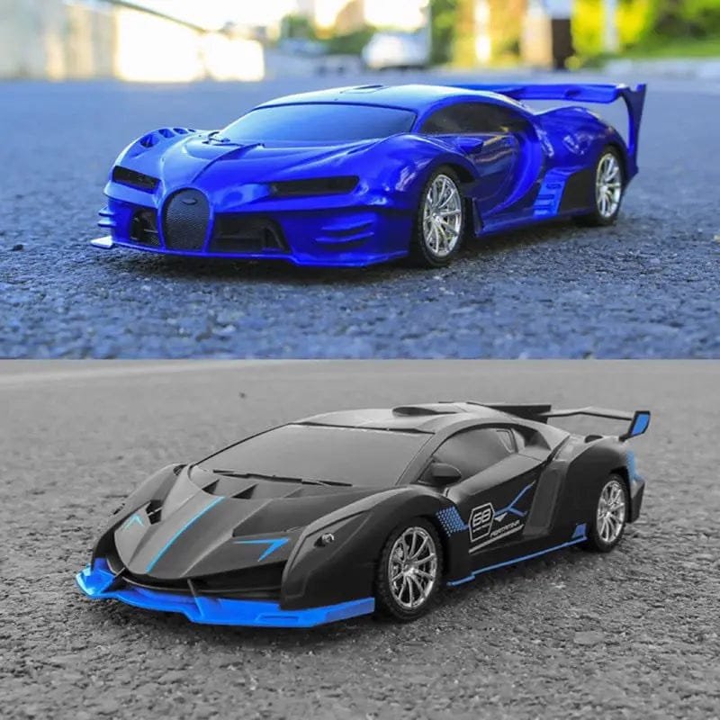 Two toy cars, one blue and one black with blue accents, on a road.