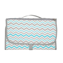Chevron print baby diaper changing bag folded into portable carry form for quick outings and errands with baby.