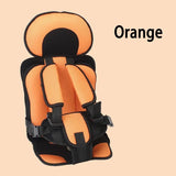 Orange and black child safety seat on a beige background