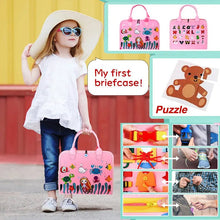 Child holding the pink Montessori Busy Board briefcase featuring a puzzle and toy car for travel play.