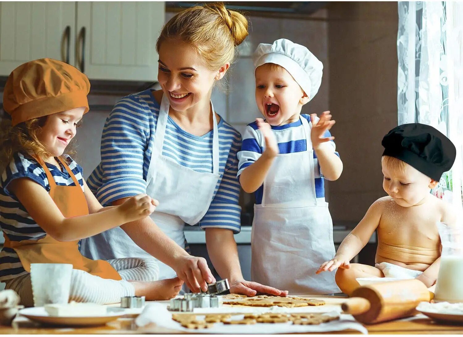 Childrens cooking apron set worn while baking cookies with an adult, keeping clothes clean during family kitchen time.