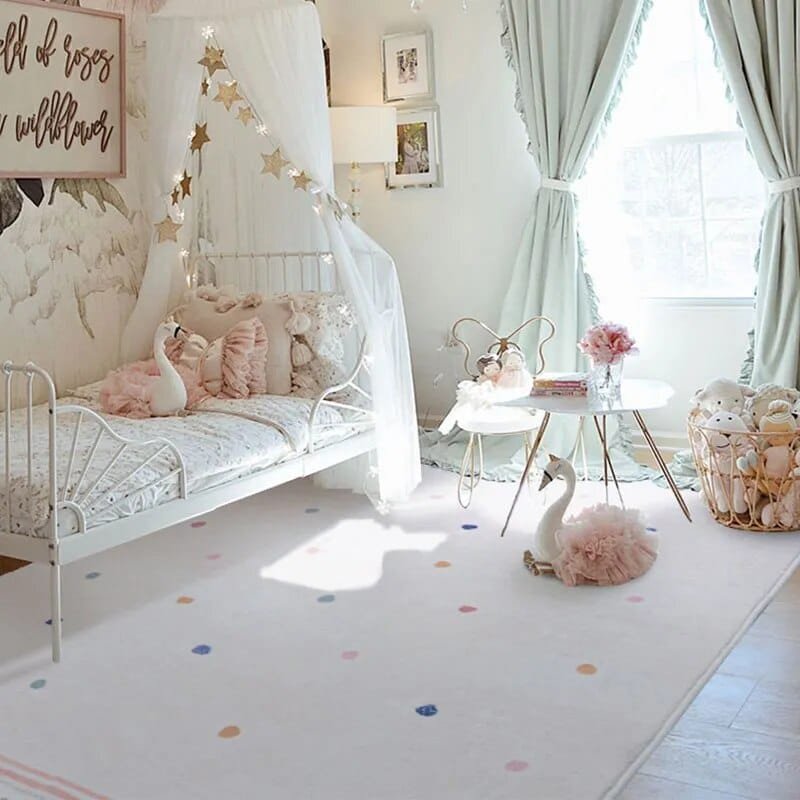 Children's bedroom with a white canopy bed, swan decorations, and a polka dot rug