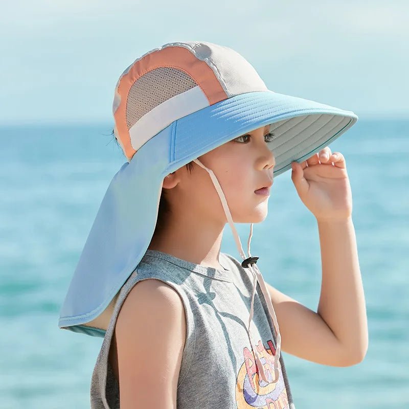 Child wearing a colorful sun hat with a beach background