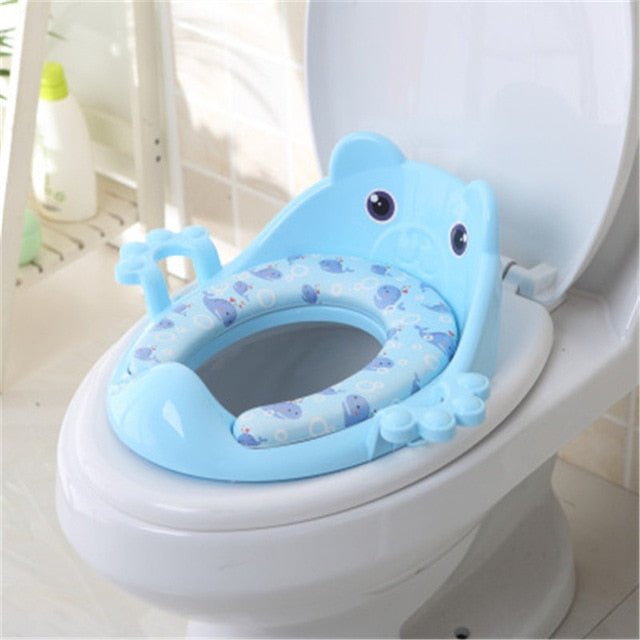 Blue children's toilet seat with cartoon design on a white toilet.