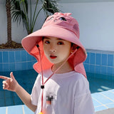 Person wearing a pink sun hat with a pool in the background