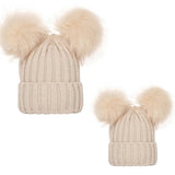 Beige knit beanie with two fluffy pom-poms