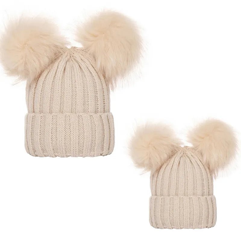Beige knit beanie with two fluffy pom-poms