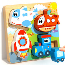Wooden puzzle board with airplane, rocket, train and a red vehicle piece, with a hand placing a blue piece