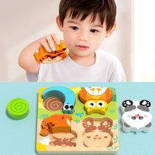 Boy holding a wooden tiger piece above an animal puzzle board with panda and snail pieces